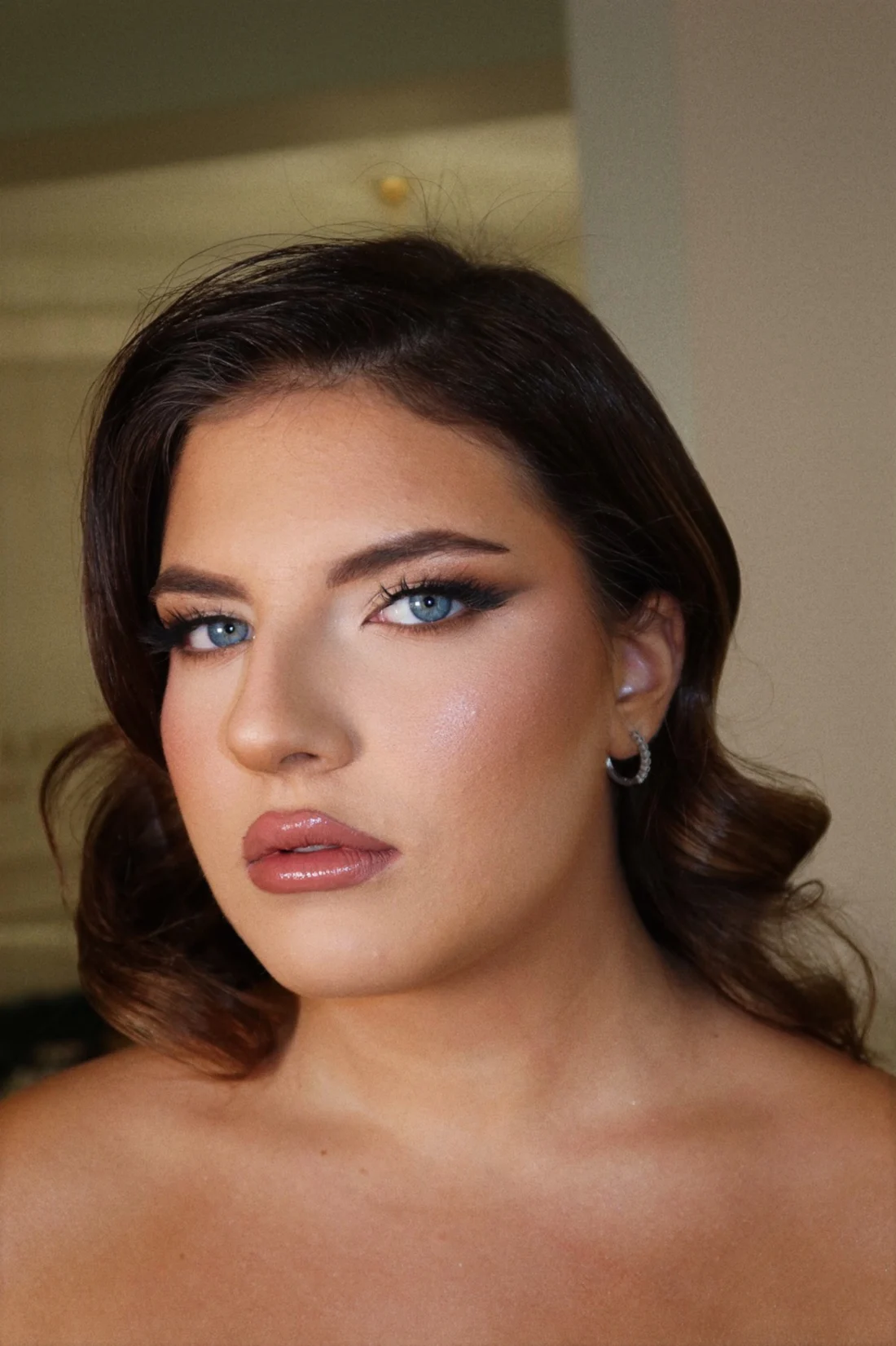 Makeup sfumato con labbra lucide e capelli a onde